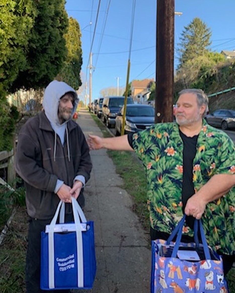 Robert, 15-year office manager at Astoria Rescue Mission, with a volunteer who helped unload linens