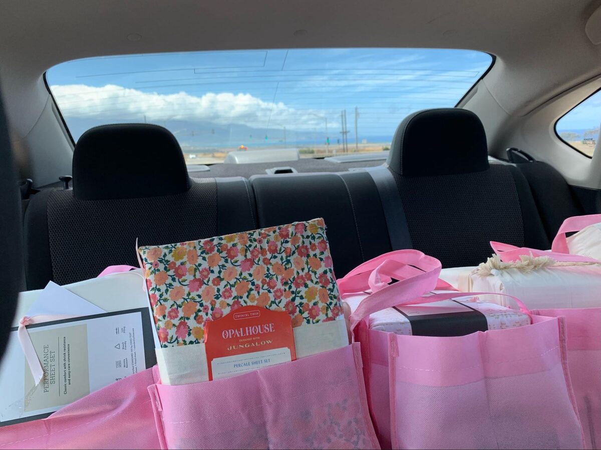 The Linen Closet signature delivery bags packed with sheet sets for transitional housing partners