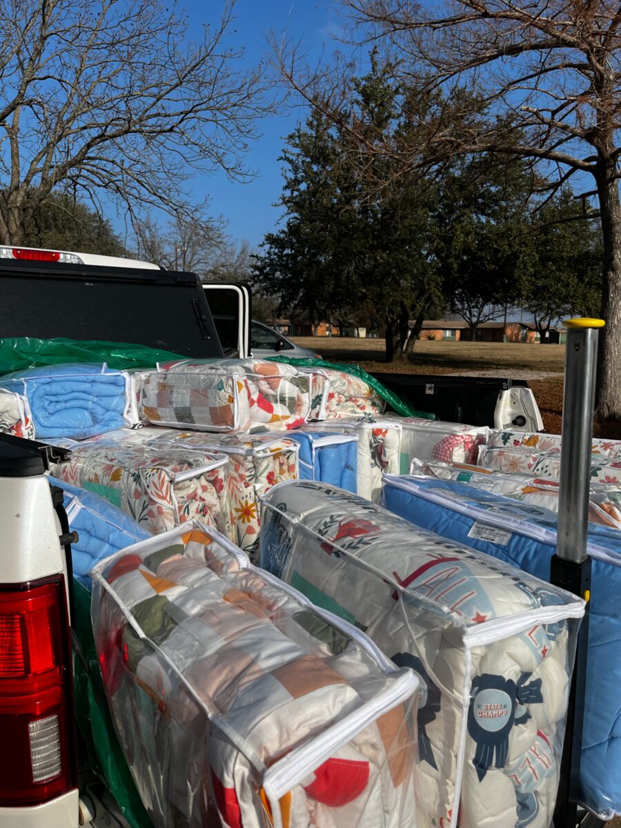 Kandi Shaw with The Linen Closet delivery of children's sheets and comforters at PCHAS near Dallas, Texas