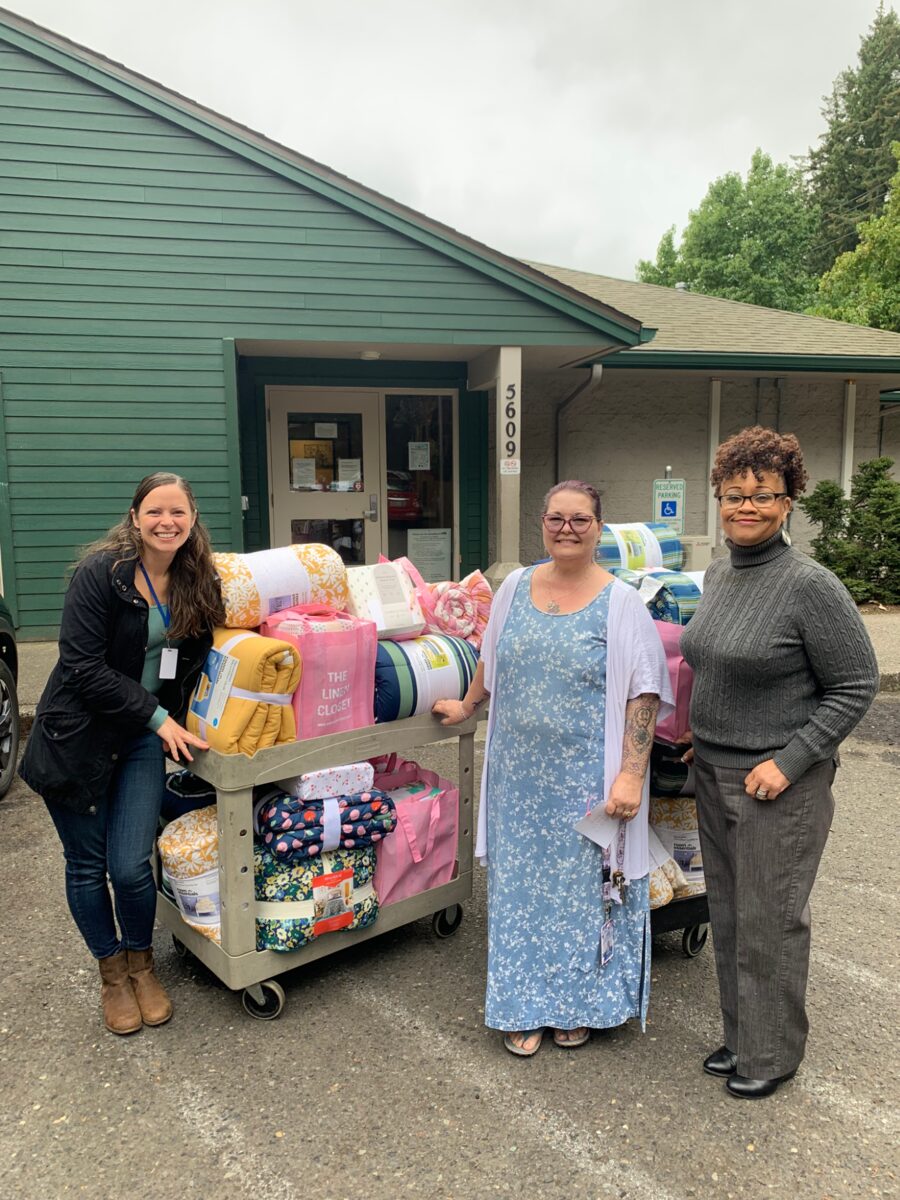 Molly Evjen, Clara, and Robin at Share Vancouver's Orchard Inn with new bedding