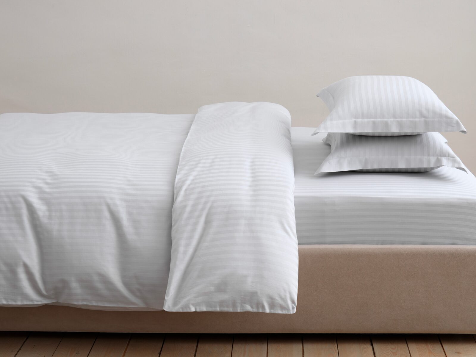 Fresh white bed linens neatly arranged on a bed