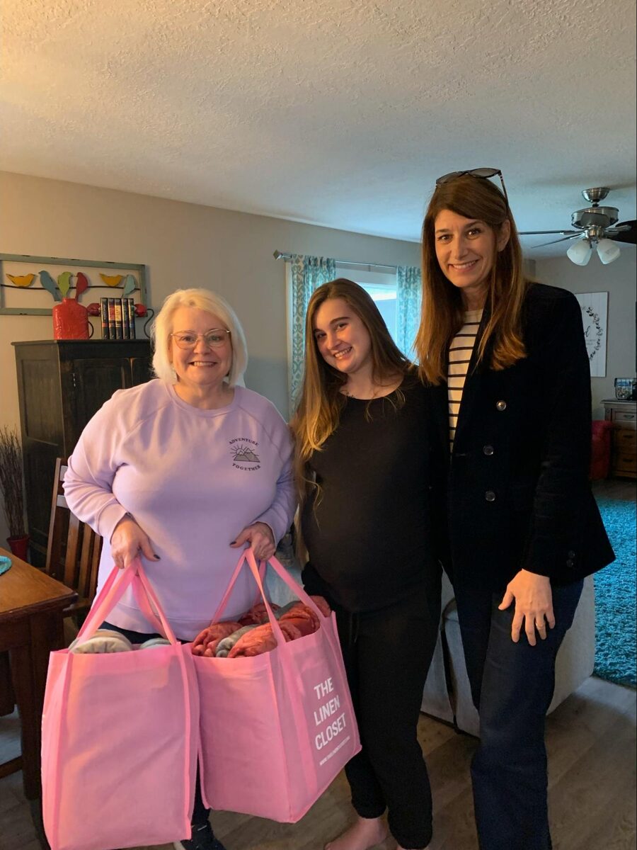 Cindy Sorum at Saving Grace Maternity Home with blankets delivered by The Linen Closet